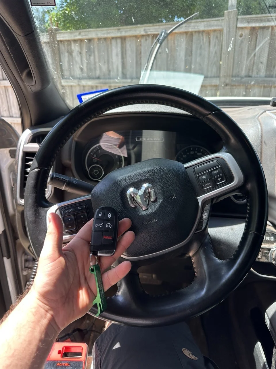 Ram key fob beside a Ram steering wheel — Lock Pick work gallery