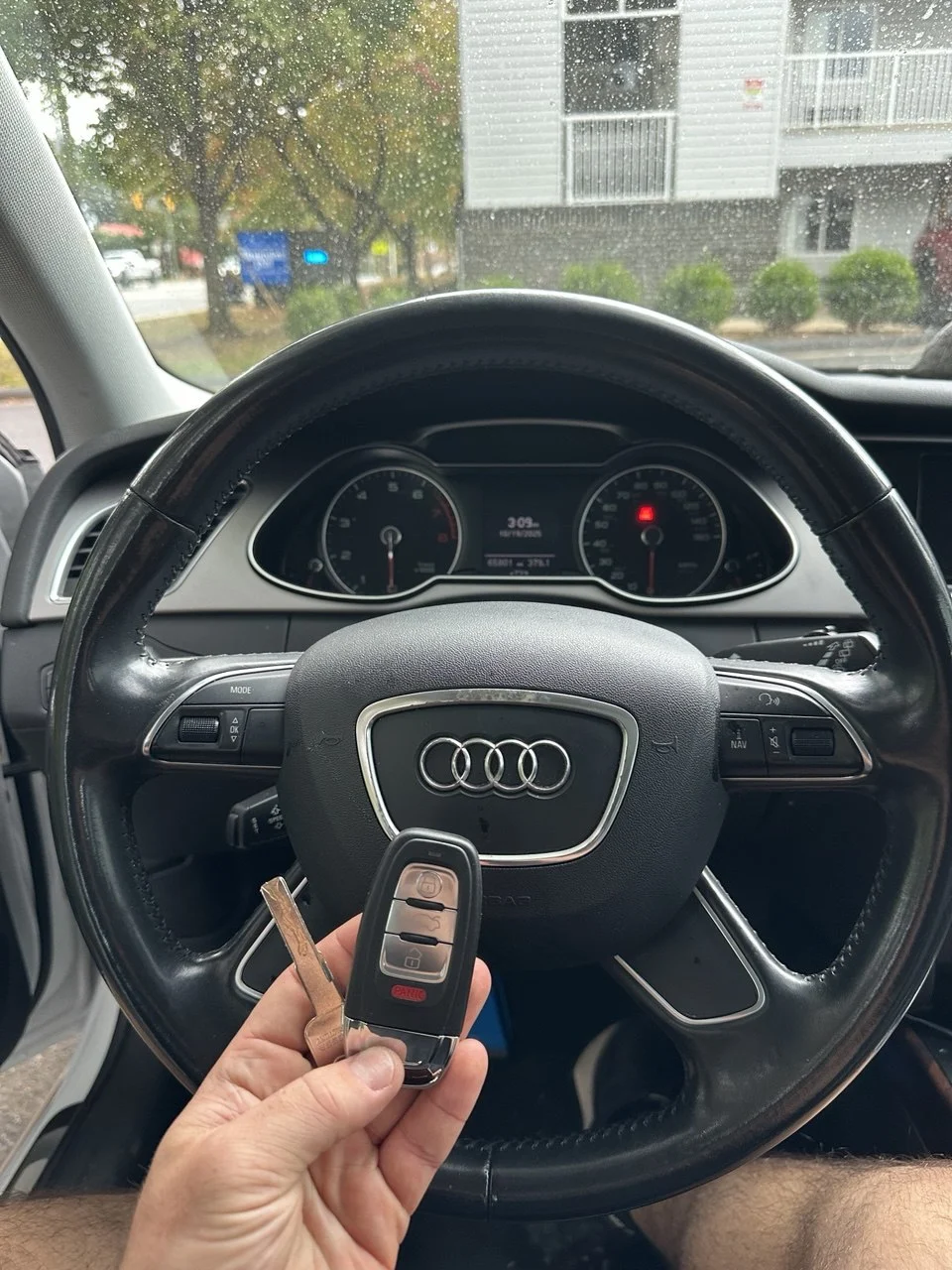 Audi key and remote beside an Audi steering wheel — Lock Pick work gallery