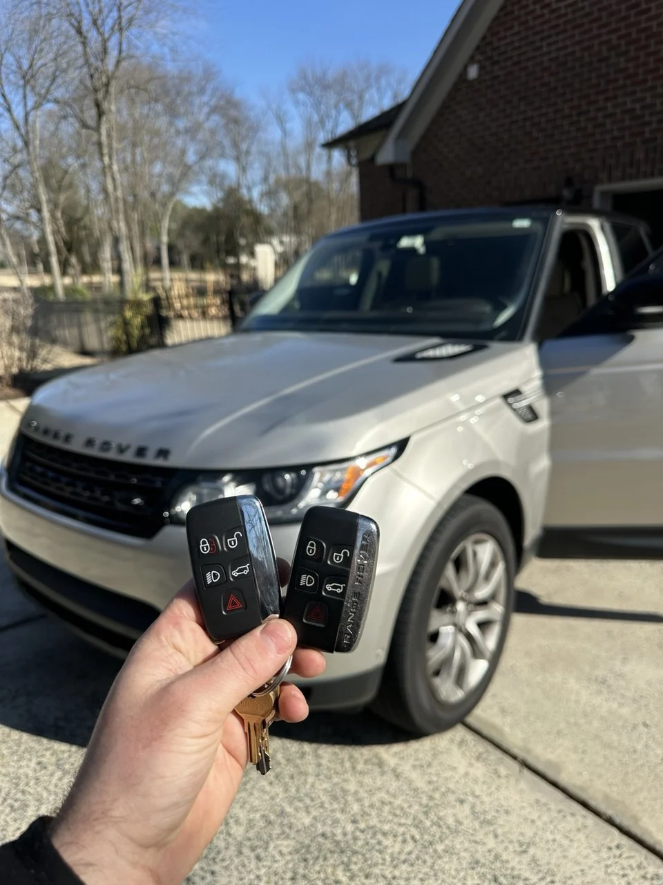 Range Rover key fobs held in front of a vehicle — Lock Pick work gallery