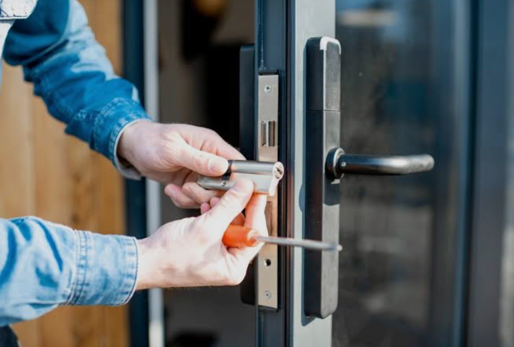 Commercial locksmith installing a door lock cylinder