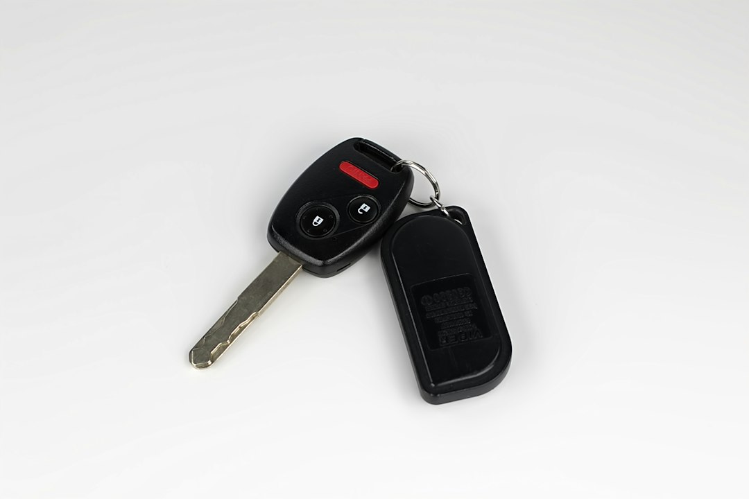 An original remote-head car key and factory keyless entry remote.